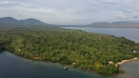 Aerial pull-back of coastline, beach, mountains, tropical forest and reef, 4k Video stock 122685807