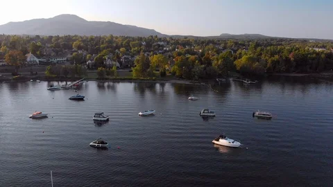 Aerial, pull back from distant town to calm lake with boats, Quebec, 4k Stock Footage 97486181