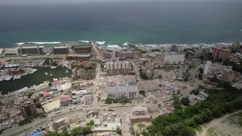 Aerial pull back drone view revealing post-earthquake devastation in Stock Footage 341431755