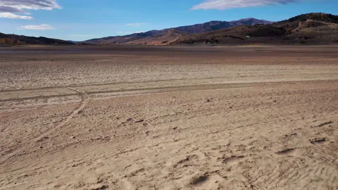 Aerial pull back of dry lake bed in the arid western United States Stock Footage 170583963