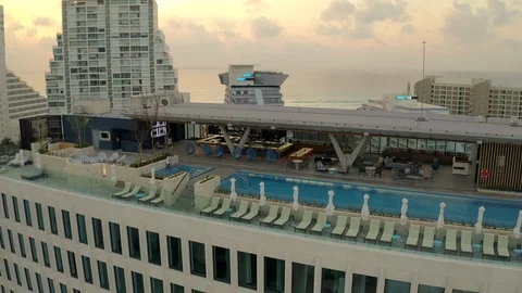 Aerial pull back from Hilton hotel pool and La Isla in cancun, mexico at sunrise Stock Footage 127205748