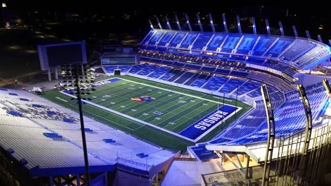 Aerial Pull-Back From the Lit New Memorial Stadium at KU Vídeos de archivo 337970264