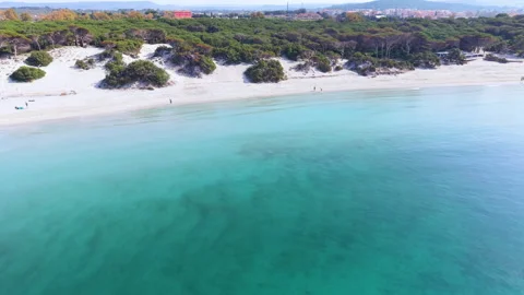 Aerial pull back of Maria Pia beach seen from the water Stock Footage 336849265