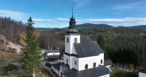 Aerial pull back from Maria Śnieżna Sanctuary on Igliczna in autumn Stock Footage 346663433