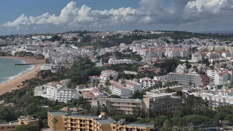 Aerial pull back over Albufeira and Praia dos Pescadores in spring Stock Footage 346651771