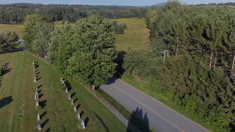 Aerial,  pull back over country cemetery, summer Stock Footage 97768970