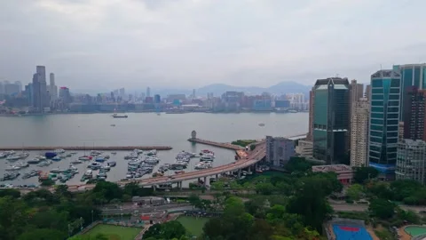 Aerial pull back over Island Eastern Corridor traffic Causeway Bay marina Stock Footage 336341627