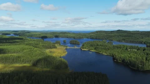 Aerial pull back over Lake Savijärvi, summer in Koli national park, Finland Stock Footage 346647844