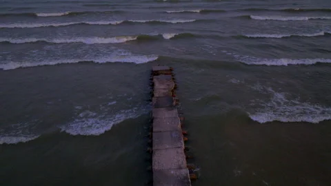 Aerial Pull Back Over Old Concrete Pier on Lake Michigan at Dusk Toward Shore Stock Footage 316214628