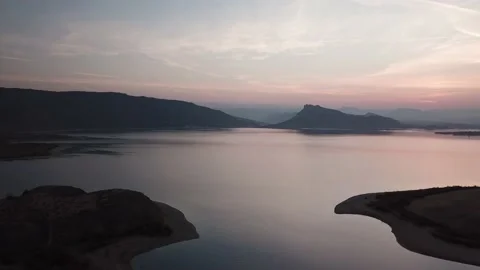 Aerial Pull Back Over Quiet Gorge Surrounded By Mountains At Sunset Stock-Footage 145821091