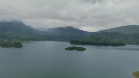 Aerial Pull Back Over Vast Lake Away From Gartmore Falls and Mountains Stock Footage 346437535