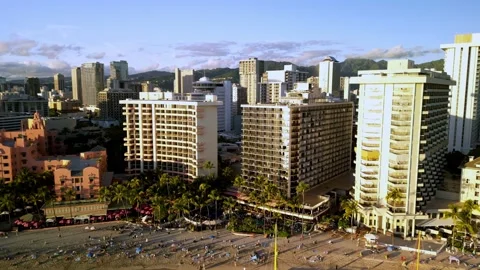 Aerial pull back over Waikiki Beach hotels and catamarans, Hawaii Stock Footage 339634195