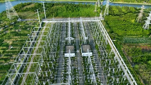 Aerial Pull Back Reveal of High Voltage Electrical Substation and Power Grid 動画素材 341596251