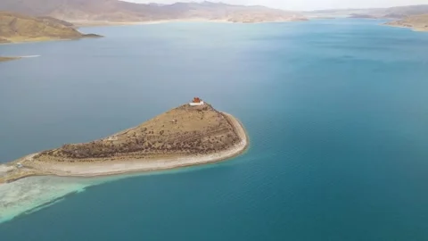 Aerial Pull Back Revealing Isolated Monastery on Island in Yamdrok Lake, Tibet Stock Footage 326205680