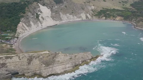 Aerial Pull Back Revealing Lulworth Cove on the Jurassic Coast Dorset Stock Footage 346737579