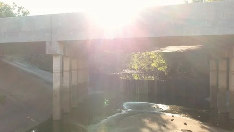 Aerial pull back revealing under sinister looking bridge 스톡 동영상 96348207