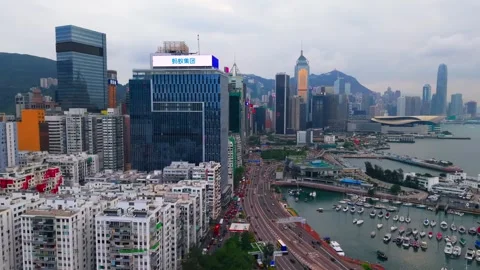 Aerial pull back revealing Victoria Harbour Hong Kong cityscape and Causeway Stock Footage 336341223