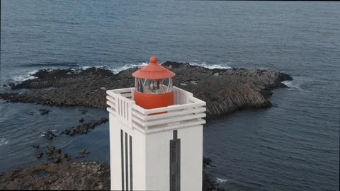 Aerial pull back revealing view of a lighthouse by the sea in West Iceland Stock Footage 116185402