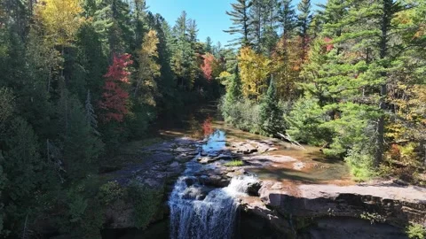 Aerial Pull Back Reveals Waterfall and Vibrant Autumn Colors Stock Footage 315265280
