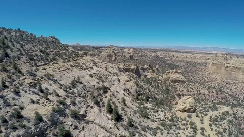 Aerial-pull back rugged desert vista canyon rock formations Stock Footage 75334636