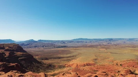 Aerial-Pull back-Rugged desert sandstone cliffs from distant valley Stock Footage 117402052