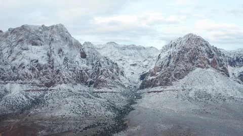 Aerial pull back shot of colorful desert mountains range at Red Rock Canyon Stock Footage 122053541