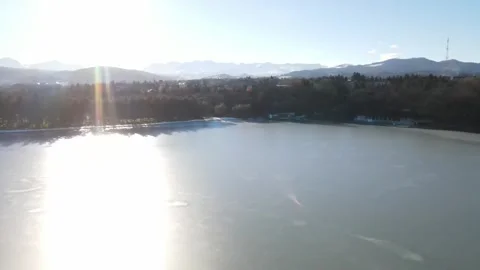 Aerial pull-back shot of a frozen winter pond Stock Footage 337997997