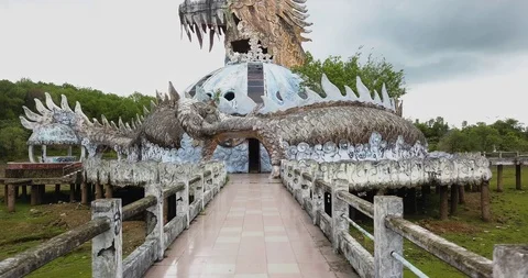 Aerial pull back shot of giant abandoned dragon statue in Hue Vietnam Stock Footage 97430264
