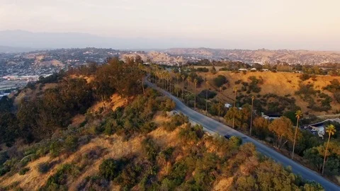 Aerial pull back shot of hills above Los Angeles Stock-Footage 76677566