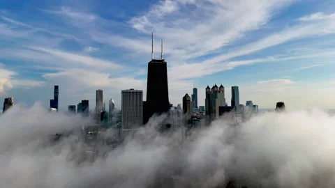 Aerial pull back shot of low hanging clouds in front of the Chicago skyline Video stock 311505208