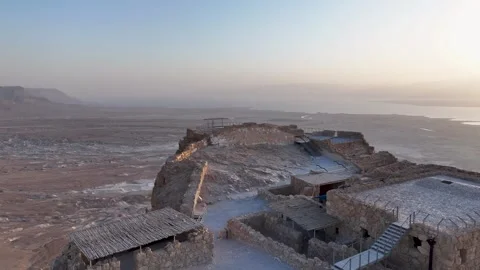Aerial pull back shot of Masada fortress lookout point facing the Dead Sea at Stock Footage 340541670