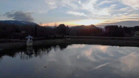 Aerial: Pull back shot of this mirror lake with birds diving in the water 库存影片 127773221