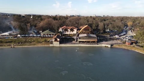 Aerial pull-back shot of the Panorama restaurant and lake, Nalchik Stock Footage 338005046