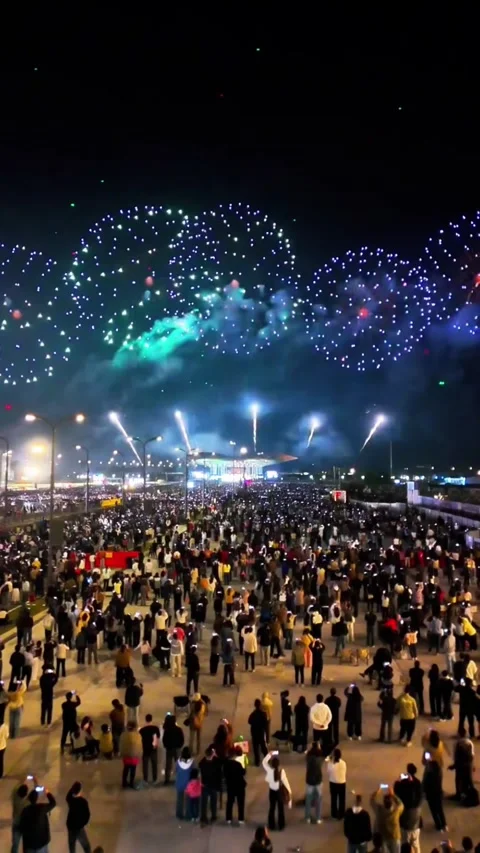 Aerial Pull-back Shot of People Watching Colorful Fireworks for Chinese New Stock Footage 328964086