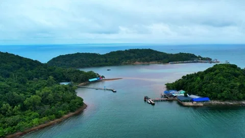 Aerial pull back shot revealing three tropical islands from boat pier 4K Stock Footage 336887897