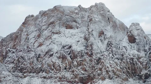 Aerial pull back shot of snow covered Mount Wilson mountain at Red Rock Canyon Video stock 122052544