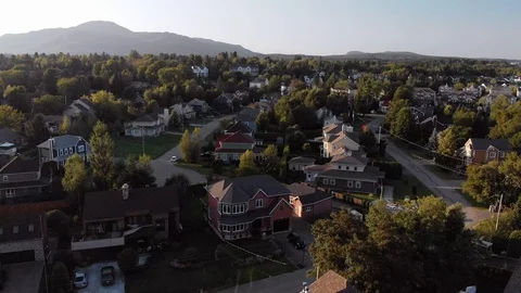 Aerial, pull back from small town to calm lake with boats, Quebec, 4k Stock Footage 97546401