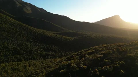 Aerial pull back at sunset in Australian mountain ranges Stock Footage 232452428