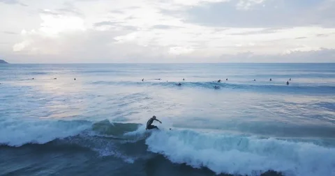 Aerial Pull Back of Surfer Swiming a Wave on the Sea in Brazil, Florianópolis Vídeo Stock 101554623