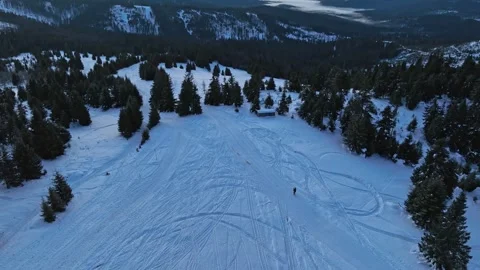 Aerial pull back tilt up showing hiker silhouette before sunrise Stock Footage 336446211