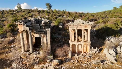 Aerial Pull Back of Two Ancient Stone Mausoleums in Rural Turkey Stock Footage 324135340