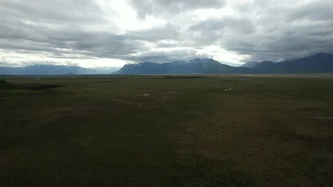 Aerial Pull Back With View of Alaska Wilderness Under Dramatic Cloudy Sky Vídeo Stock 170165742