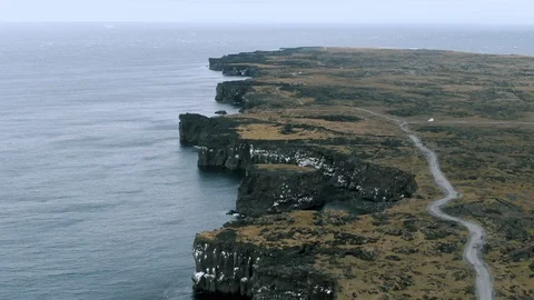 Aerial pull back view of a black rocky coastline in West Iceland Stock Footage 116545027