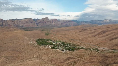 Aerial pull back view of Blue Diamond with Red Rock Canyon peaks in background Stock Footage 122905620