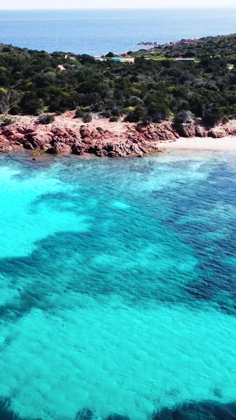 Aerial pull back view of Capo Coda Cavallo shore Stock Footage 340354380
