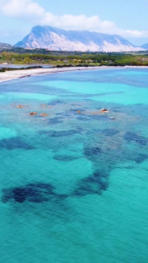 Aerial pull back view of Lu Impostu beach in springtime Stock Footage 340354393