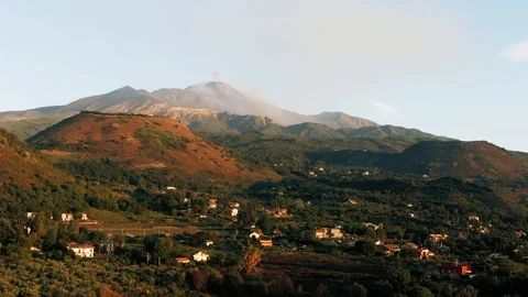 Aerial pull back view of mount Etna in Sicily with small craters at sunrise Stock Footage 117351620