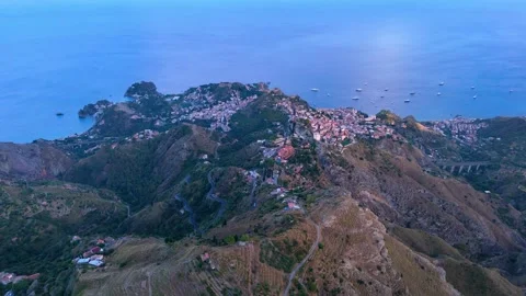 Aerial pull back view of Taormina and Castelmola in Sicily Stock Footage 305652639