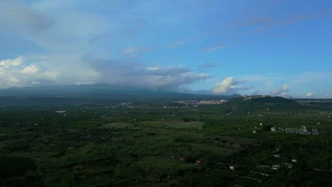 Aerial pull-back view of the town of Paternò in Sicily with Mount Etna Stock Footage 288205934