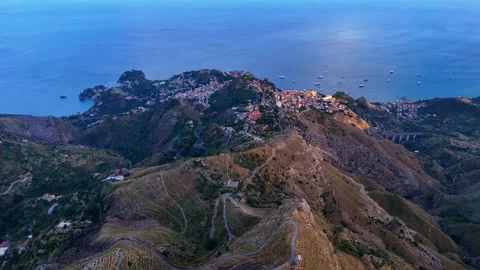 Aerial pull back view of the towns of Taormina and Castelmola in Sicily 動画素材 312734836